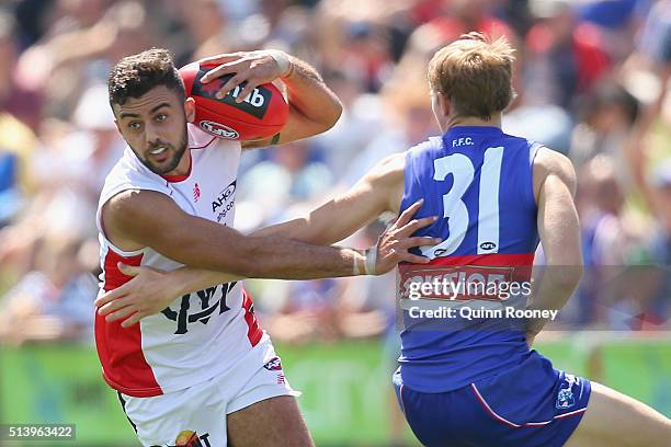 Christian Salem of the Demons avoids a tackle by Bailey Dale of the Bulldogs during the 2016 AFL NAB Challenge match between the Western Bulldogs and...