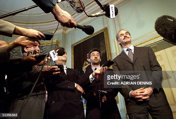 Greek Foreign Minister George Papandreou is surrounded by Greek journalists at Britain's Foreign Secretary Robin Cook's London residence, Carlton...