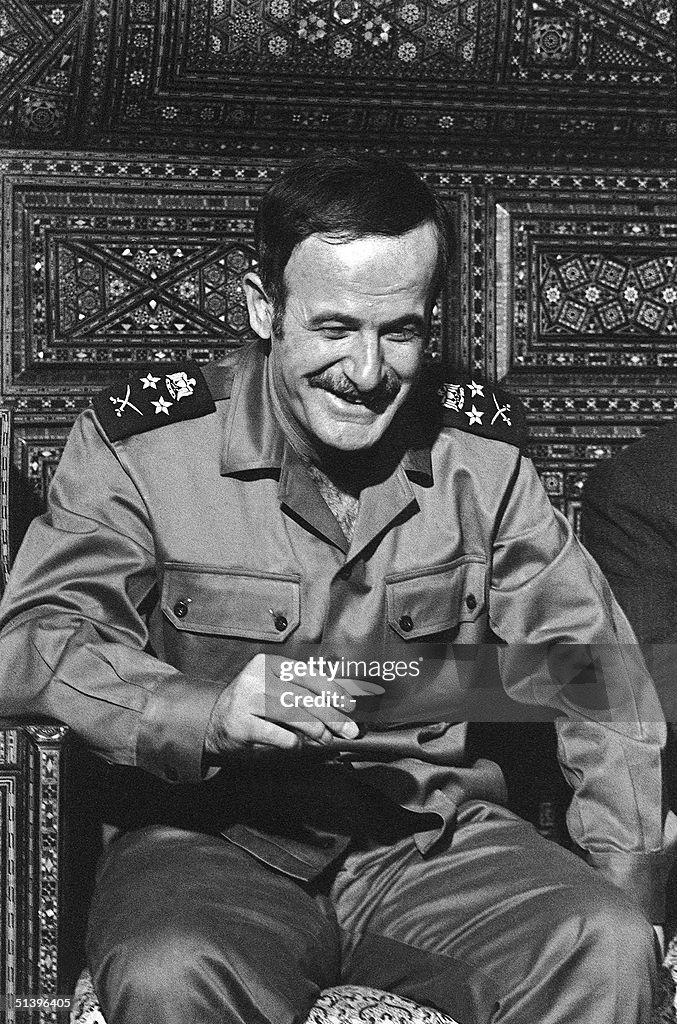 Syrian President Hafez al-Assad drinks a cup of co