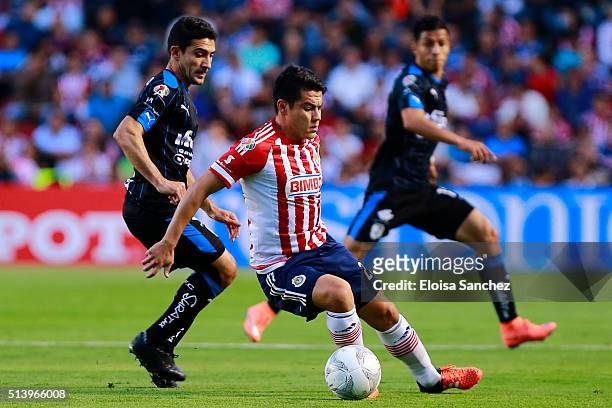 Antonio Naelson of Queretaro struggles for the ball with Michael Perez of Chivas during the 9th round match between Queretaro and Chivas as part of...