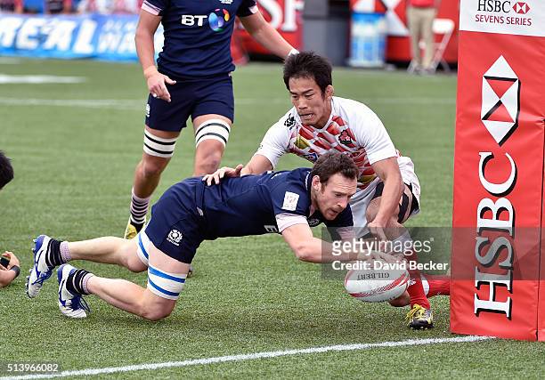 Scott Riddell of Scotland dives in for a try against Yusaku Kuwazuru of Japan during the USA Sevens Rugby tournament against Japan at Sam Boyd...