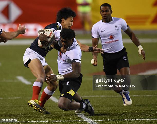 Savenaca Rawaca of Fiji is takled by Kazuhiro Goya of Japan during their quarterfinal game on day two of the Men's 2016 USA Sevens Rugby Tournament...