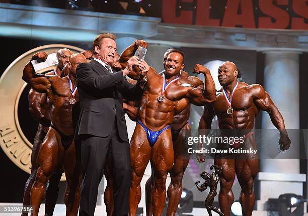 Arnold Schwarzenegger takes a photo with then winner's of the Arnold Classic at the Arnold Sports Festival 2016 on March 5, 2016 in Columbus, Ohio.