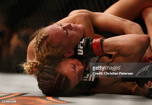 Miesha Tate attempts to submit Holly Holm in their UFC women's bantamweight championship bout during the UFC 196 event inside MGM Grand Garden Arena...
