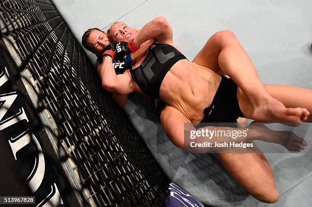 Miesha Tate attempts to submit Holly Holm in their UFC women's bantamweight championship bout during the UFC 196 event inside MGM Grand Garden Arena...