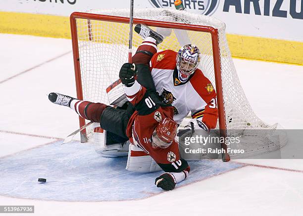 Anthony Duclair of the Arizona Coyotes collides with goaltender Al Montoya of the Florida Panthers during the third period at Gila River Arena on...