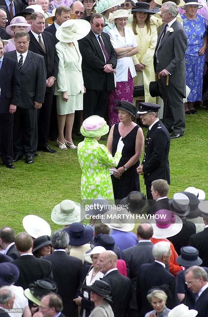 Britain's Queen Elizabeth II talks to a couple of