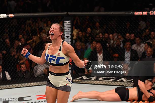 Miesha Tate reacts after her submission victory over Holly Holm in their UFC women's bantamweight championship bout during the UFC 196 event inside...