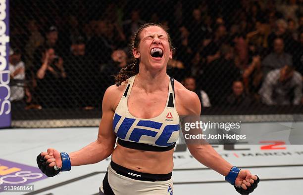 Miesha Tate reacts after her submission victory over Holly Holm in their UFC women's bantamweight championship bout during the UFC 196 event inside...