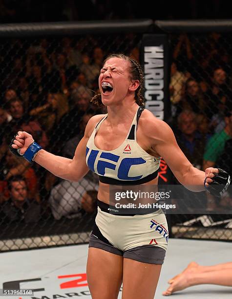 Miesha Tate reacts after her submission victory over Holly Holm in their UFC women's bantamweight championship bout during the UFC 196 event inside...