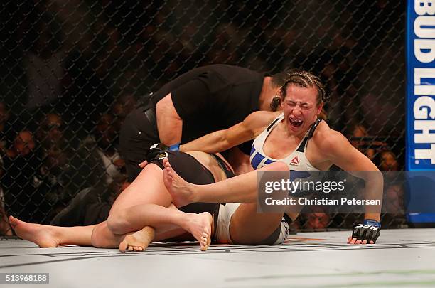 Miesha Tate reacts to her victory over Holly Holm in their UFC women's bantamweight championship bout during the UFC 196 event inside MGM Grand...