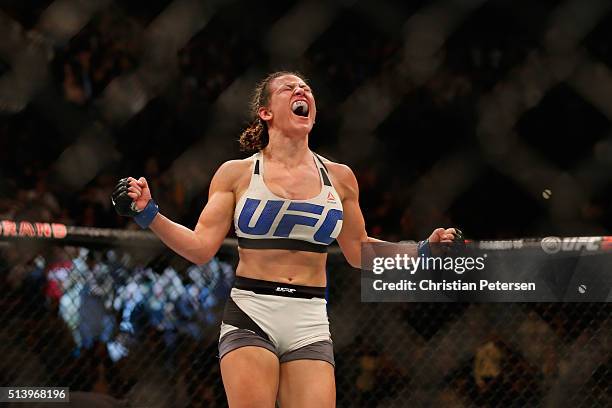 Miesha Tate reacts to her victory over Holly Holm in their UFC women's bantamweight championship bout during the UFC 196 event inside MGM Grand...