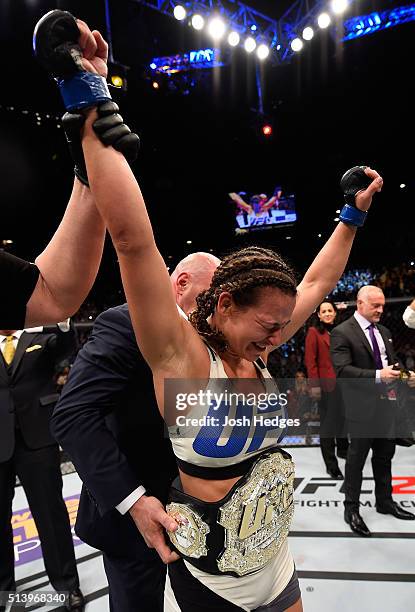 Miesha Tate reacts to her victory over Holly Holm in their UFC women's bantamweight championship bout during the UFC 196 event inside MGM Grand...