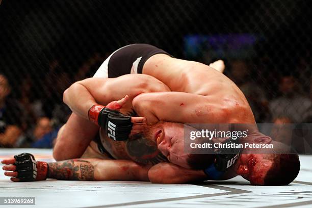 Nate Diaz attempts to submit Conor McGregor of Ireland in their welterweight bout during the UFC 196 event inside MGM Grand Garden Arena on March 5,...