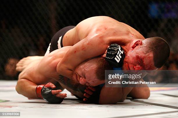 Nate Diaz attempts to submit Conor McGregor of Ireland in their welterweight bout during the UFC 196 event inside MGM Grand Garden Arena on March 5,...