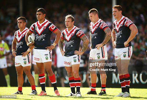 Roosters players look dejected after a Rabbitohs try during the round one NRL match between the Sydney Roosters and the South Sydney Rabbitohs at...