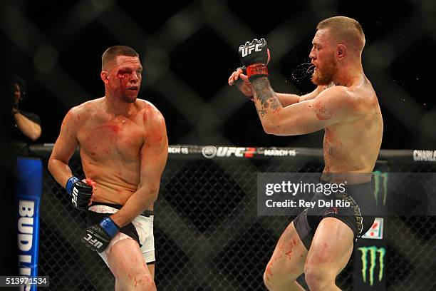 Nate Diaz punches Conor McGregor during UFC 196 at the MGM Grand Garden Arena on March 5, 2016 in Las Vegas, Nevada.