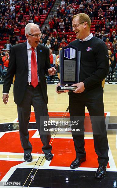 Head coach Steve Fisher and Athletic Director Jim Sterk of the San Diego State Aztecs celebrate with the trophy after winning the MW Conference...