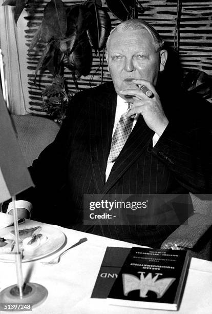 Professor Ludwig Erhard, minister of Economy for West-Germany smokes his first Finnish cigar at a press meeting 20 September 1956 in Helsinki after...