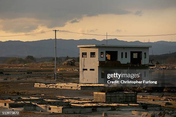 Lone house sits on the scarred landscape, inside the exclusion zone, close to the devastated Fukushima Daiichi Nuclear Power Plant on February 26,...