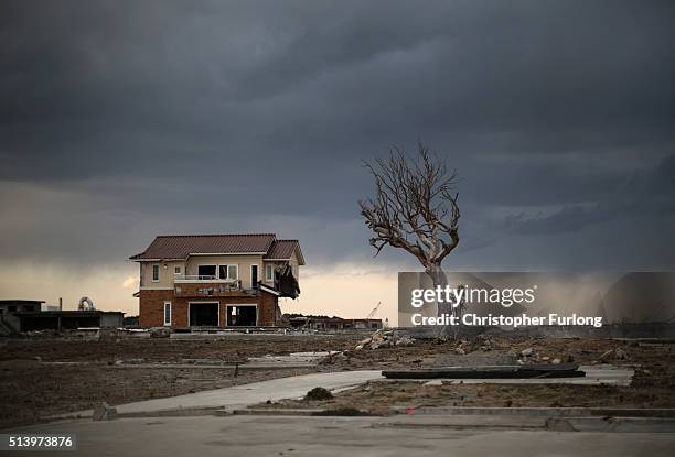 Lone house sits on the scarred landscape, inside the exclusion zone, close to the devastated Fukushima Daiichi Nuclear Power Plant on February 26,...