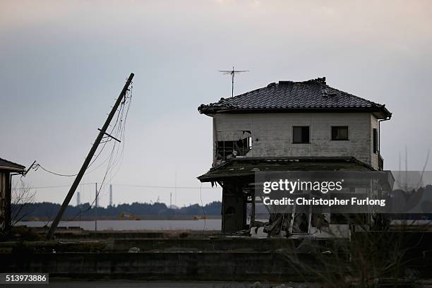 Lone house sits on the scarred landscape, inside the exclusion zone, close to the devastated Fukushima Daiichi Nuclear Power Plant on February 26,...