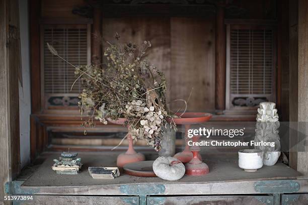 Personal items are strewn around a tsunami damaged home inside the exclusion zone close to the devastated Fukushima Daiichi Nuclear Power Plant on...