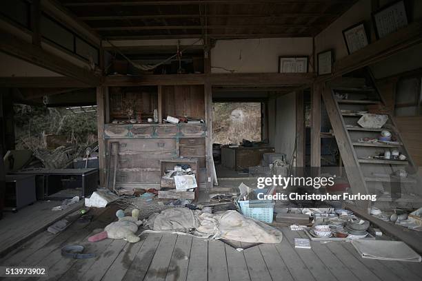 Personal items are strewn around a tsunami damaged home inside the exclusion zone close to the devastated Fukushima Daiichi Nuclear Power Plant on...