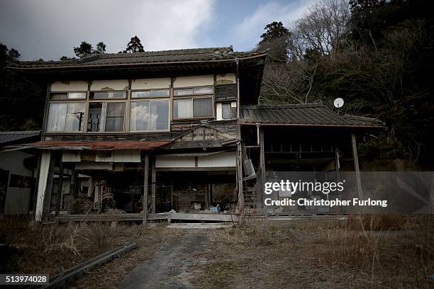 Personal items are strewn around a tsunami damaged home inside the exclusion zone, close to the devastated Fukushima Daiichi Nuclear Power Plant on...