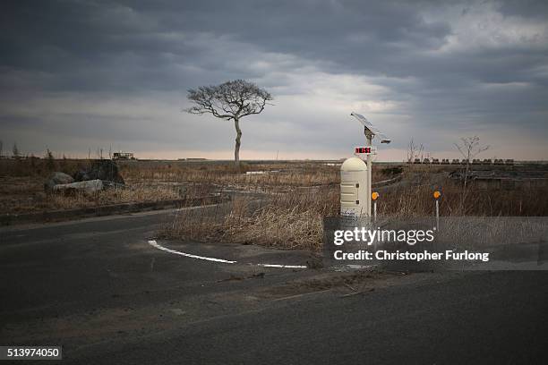 Radiation monitoring station stands in the tsunami scarred landscape, inside the exclusion zone, close to the devastated Fukushima Daiichi Nuclear...