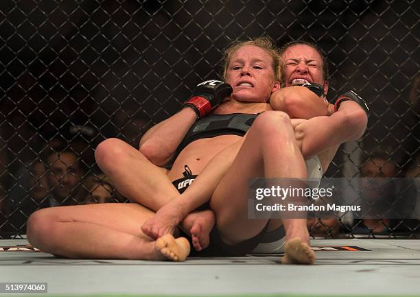 Miesha Tate submits Holly Holm during their women's bantamweight championship bout during the UFC 196 in the MGM Grand Garden Arena on March 5, 2016...