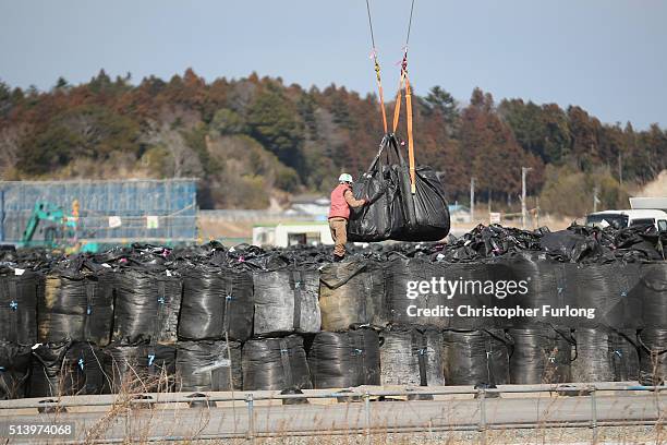 Thousands of bags of radiation contaminated soil and debris wait to be processed, inside the exclusion zone, close to the devastated Fukushima...