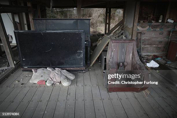 Personal items are strewn around a tsunami damaged home inside the exclusion zone, close to the devastated Fukushima Daiichi Nuclear Power Plant on...