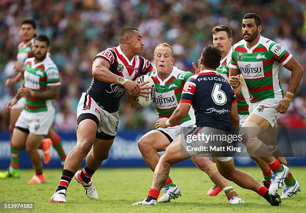 Jason Clark of the Rabbitohs is tackled during the round one NRL match between the Sydney Roosters and the South Sydney Rabbitohs at Allianz Stadium...