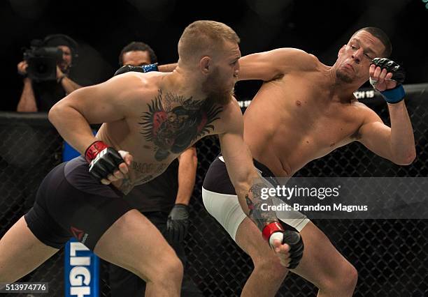 Conor McGregor punches Nate Diaz in their welterweight bout during the UFC 196 in the MGM Grand Garden Arena on March 5, 2016 in Las Vegas, Nevada.