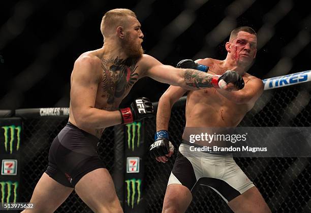 Conor McGregor punches Nate Diaz in their welterweight bout during the UFC 196 in the MGM Grand Garden Arena on March 5, 2016 in Las Vegas, Nevada.