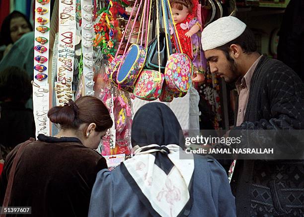 Jordanian women buy gifts on the eve of Eid al-Adha, the feast of Sacrifice, commemorating prophet Ibrahim's willingness to sacrifice his son for...