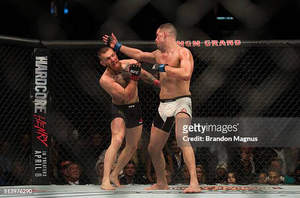 Nate Diaz punches Conor McGregor in their welterweight bout during the UFC 196 in the MGM Grand Garden Arena on March 5, 2016 in Las Vegas, Nevada.