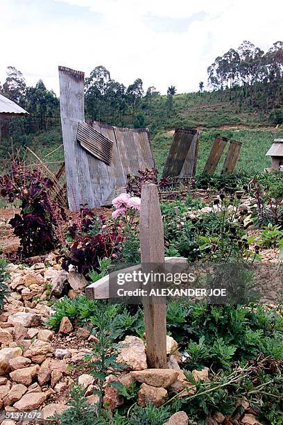 Photo taken 21 March 2000 shows an old grave next to the only standing remnants of the church of the movement for the Restoration of the Ten...