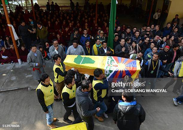 Members of the Tibetan Youth Congress carry the coffin bearing the body of Dorje Tsering during his funeral in the Indian town of McLeod Ganj on...