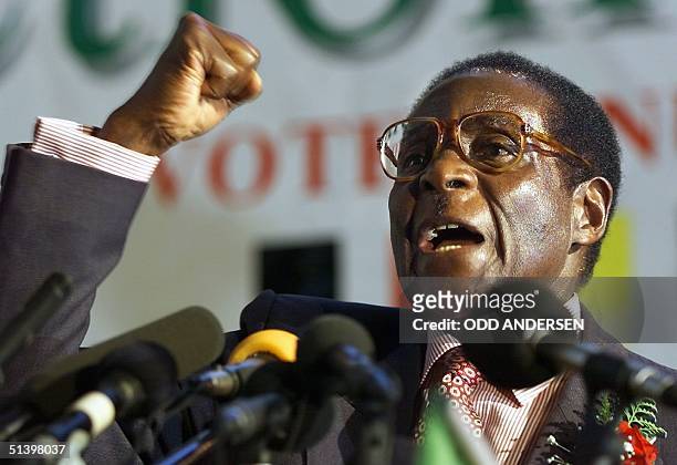 Zimbabwean President Robert Mugabe clenches his fist to salute Zanu PF comrades in Harare, 03 May 2000. Mugabe launched his ruling party election...