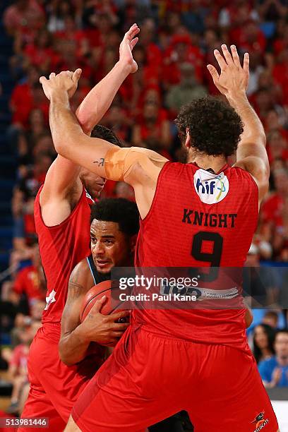 Corey Webster of the Breakers attempts pass th eball against Damian Martin and Matt Knight of the Wildcats during game three of the NBL Grand Final...