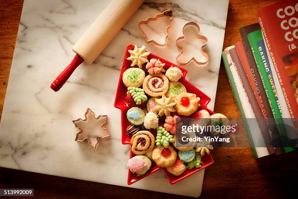 baking rolling pin, cookie cutters, baked home made christmas cookies - cookbook stock pictures, royalty-free photos & images
