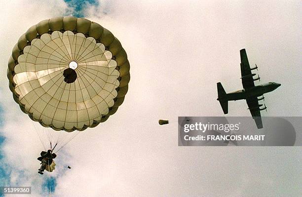 One of the 1,370 British, French and Polish paratroopers re-enacting a half-century later the Allied invasion of Normandy, glides down 05 June to...