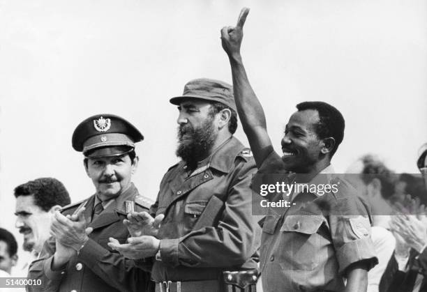 Ethiopian President Lieutenant Colonel Mengistu Haile Mariam makes V sign as he stands with Fidel Castro and Raul Castro during an official visit in...