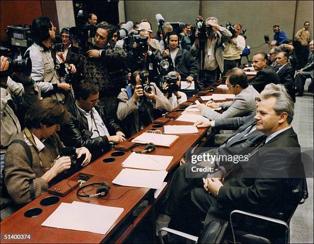 Serbian Communist Party leader Slobodan Milosevic faces a crowd of cameramen and photographers 17 October 1988 in Belgrade prior to the opening...