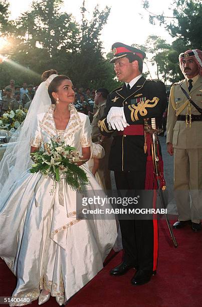 Prince Abdullah, the eldest son of Jordan's King Hussein, poses with his bride Rania Yassine after their wedding ceremony at the Royal Palace in...