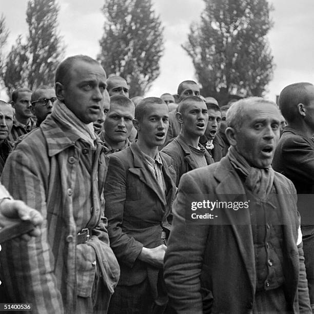 French prisoners sing the national anthem, "La Marseillaise", 18 April 1945 upon de liberation of the Nazi concentration camp of Dachau, near Munich,...