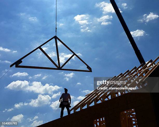 house under construction. - construction cranes stockfoto's en -beelden