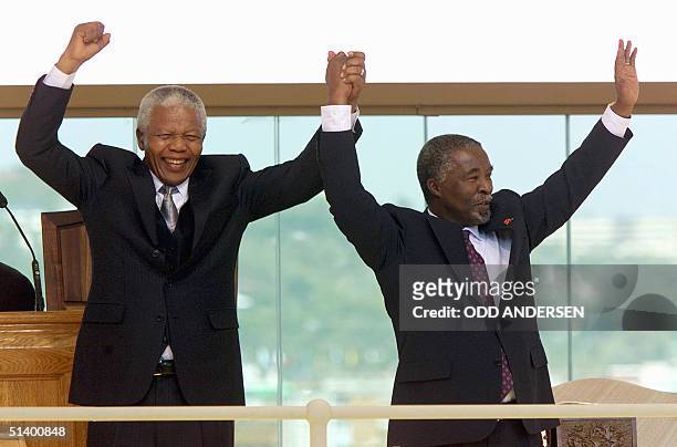 South African President Thabo Mvuyelwa Mbeki and former President Nelson Mandela acknowledge the dignitaries after Mbeki was sworn in as President of...